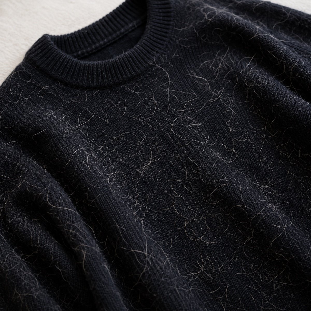 Black sweater covered in loose pet hair